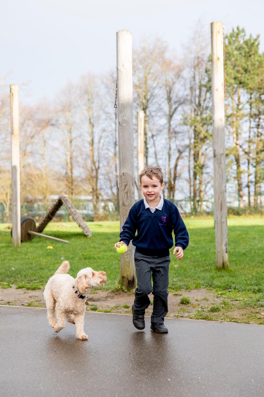 A pupil running happily alongside Skye