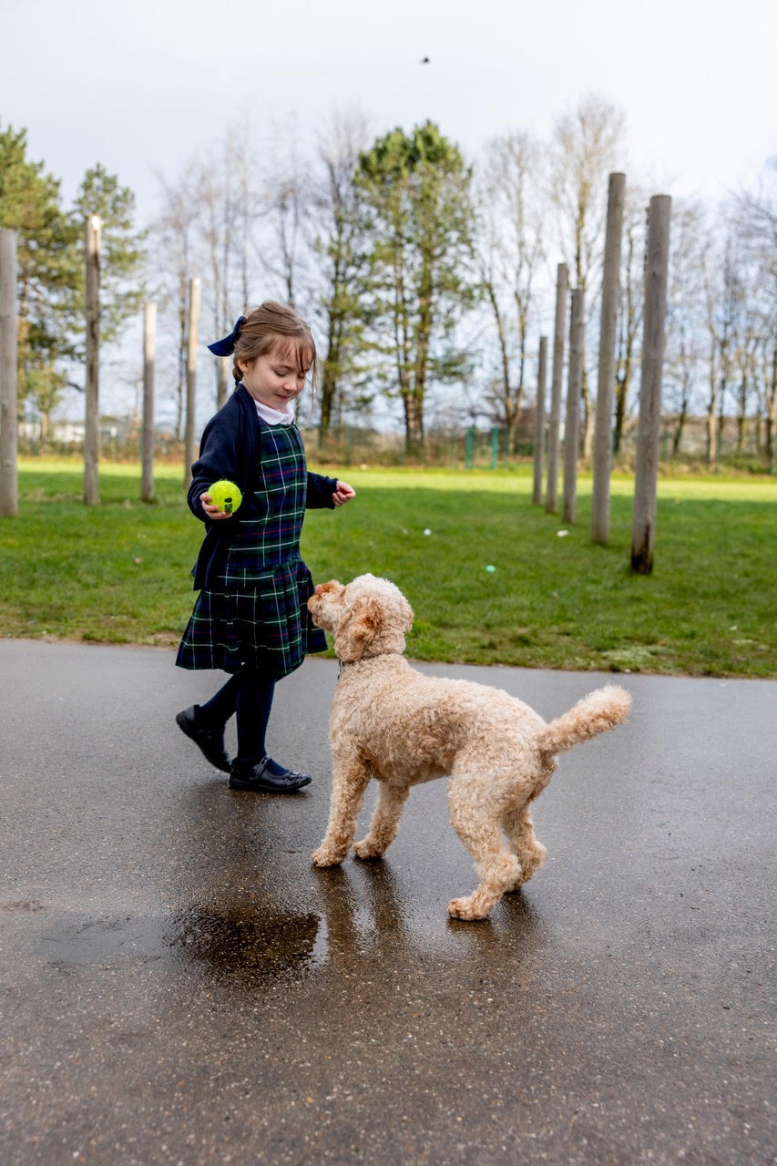 A pupil walking alongside Skye in the playground
